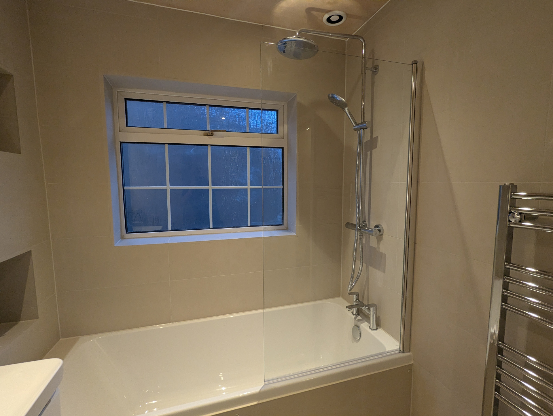 Beige bathroom with bath and shower