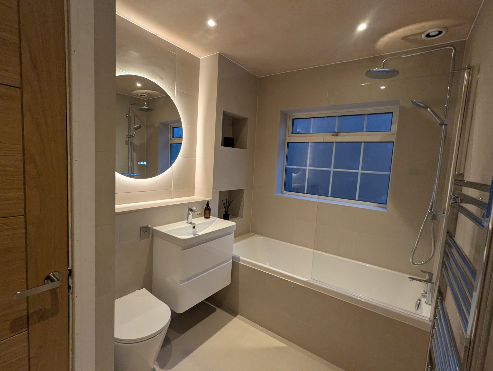 Beige bathroom with round mirror