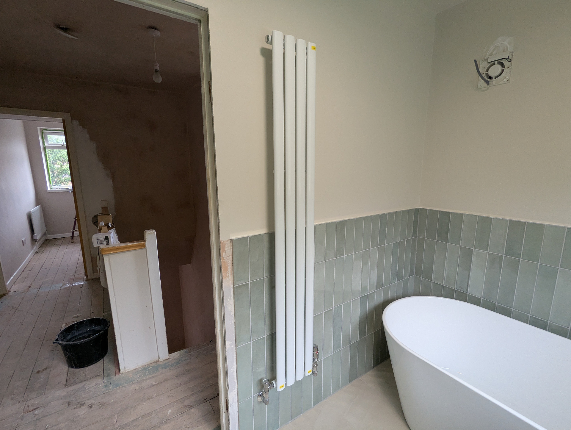 Vertical white designer radiator installation